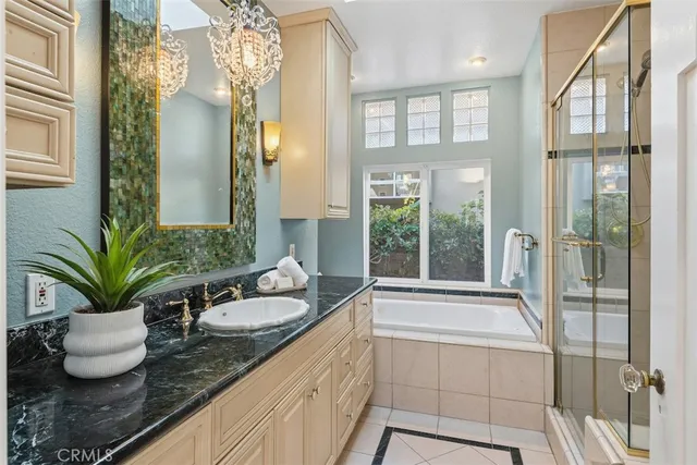 a bathroom with a granite countertop sink a large mirror and a shower