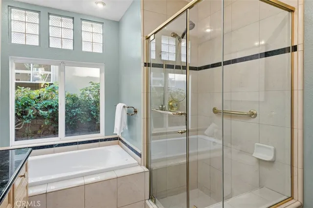 a bathroom with a tub and a shower
