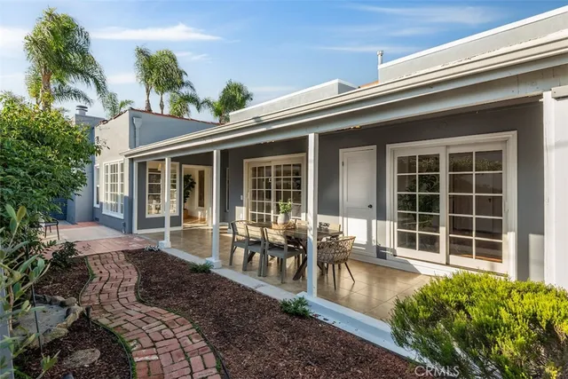 a view of a house with sitting area and garden