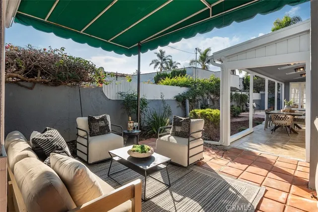 a view of a patio with a table and chairs under an umbrella