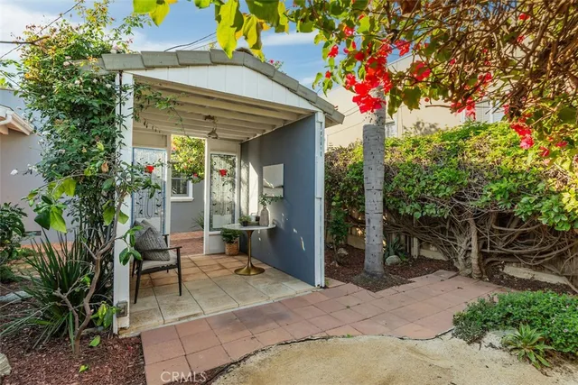 a backyard of a house with outdoor seating