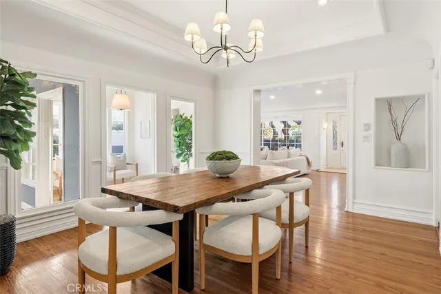 a view of a dining room with furniture wooden floor and chandelier