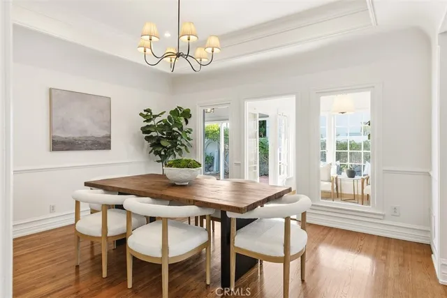a view of a dining room with furniture wooden floor and chandelier