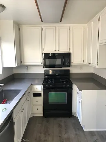 a kitchen with cabinets appliances and a sink
