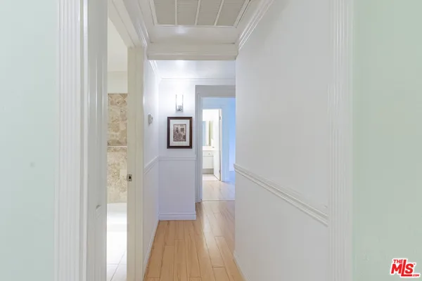 a view of a hallway with wooden floor