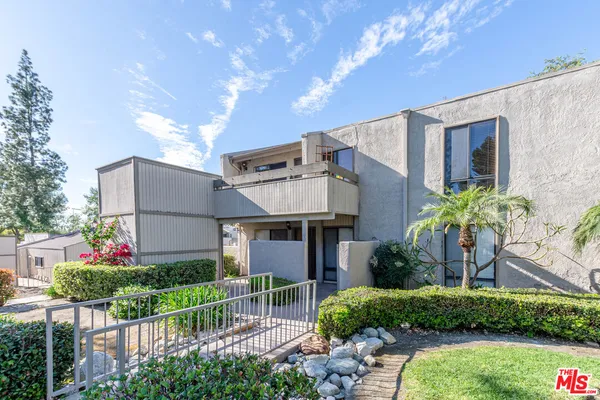 a front view of house along with yard and outdoor seating