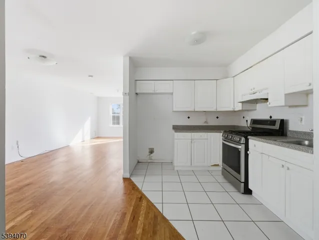 a kitchen with a stove a sink and a refrigerator