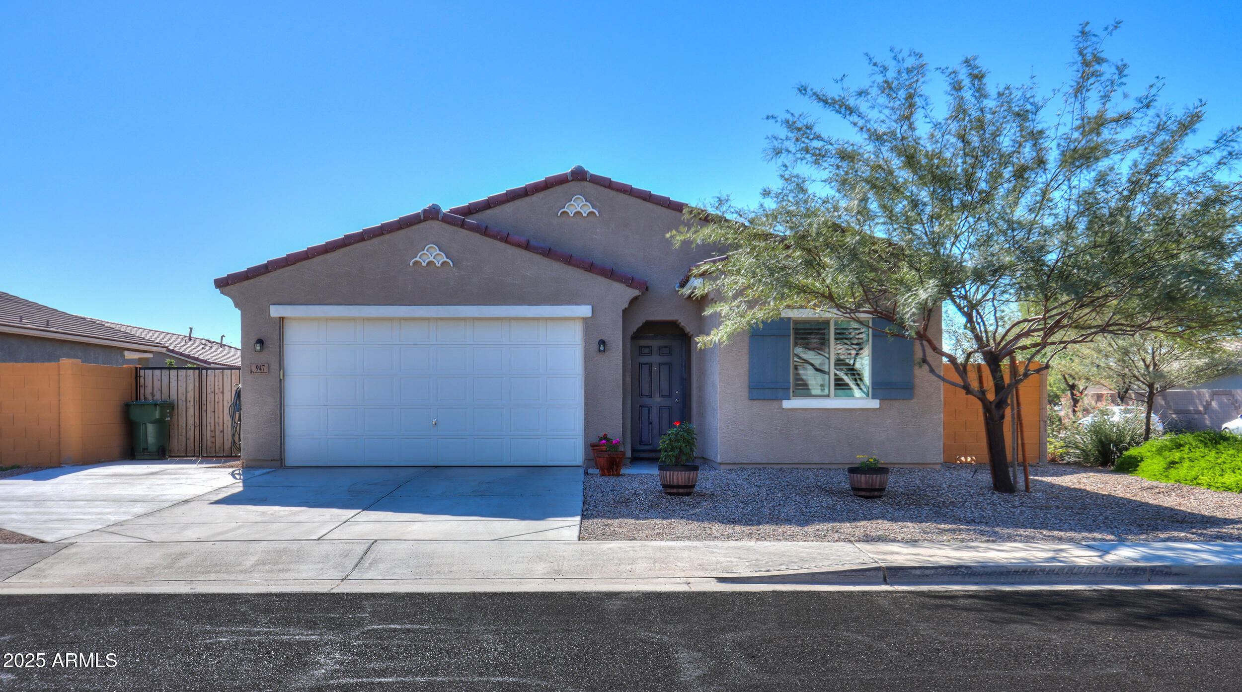 947 East Wiley Way Casa Grande, AZ 85122 - Photo 1 of 36 a front view of a house with a yard and garage