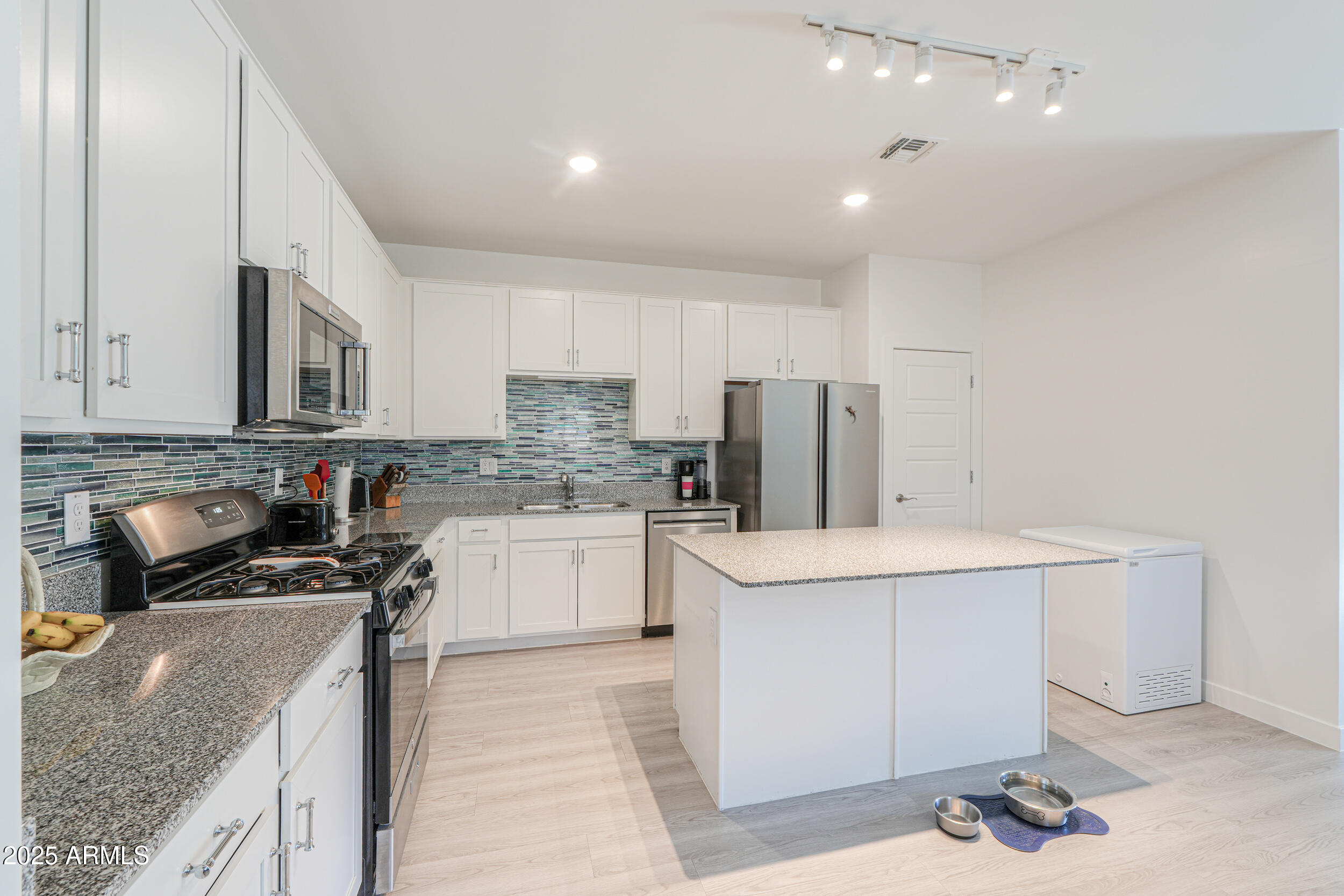 947 East Wiley Way Casa Grande, AZ 85122 - Photo 16 of 36 a kitchen that has a sink and a stove in it
