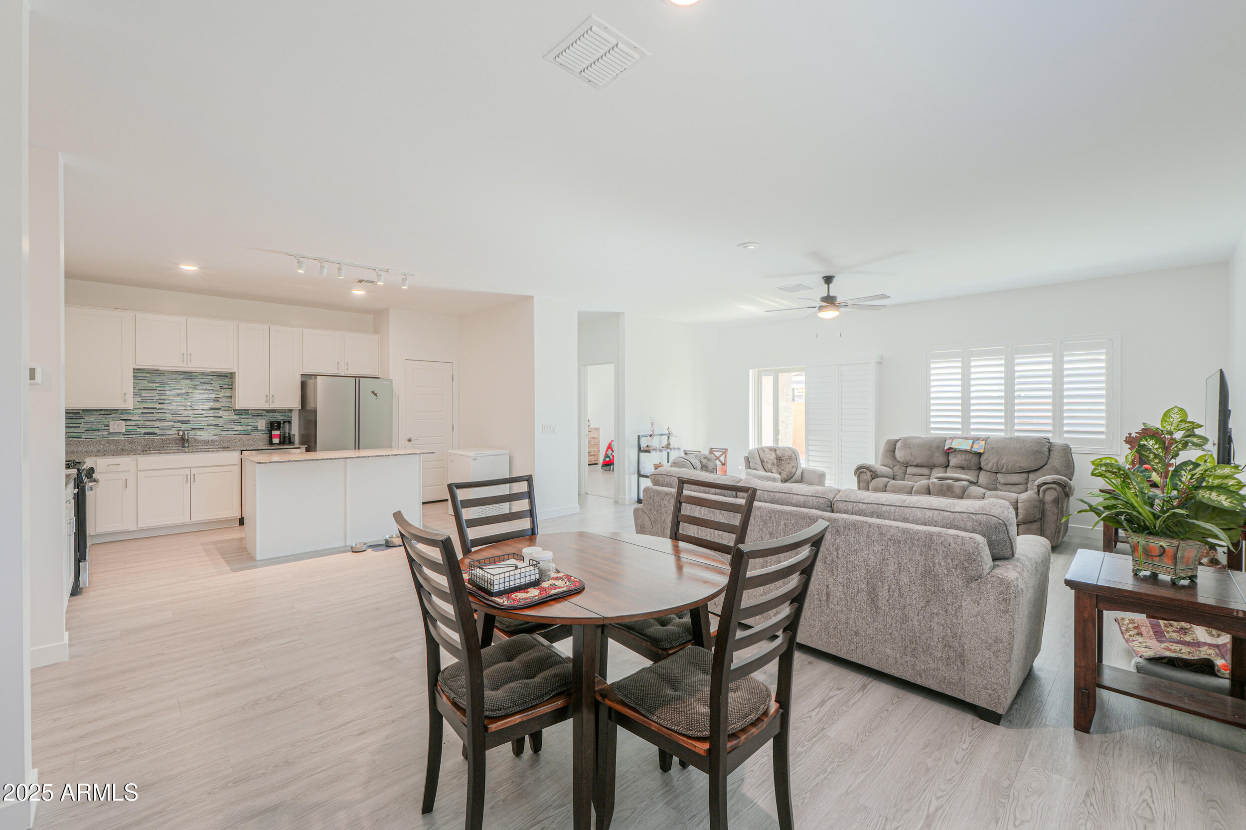 947 East Wiley Way Casa Grande, AZ 85122 - Photo 21 of 36 a view of a dining room with furniture and wooden floor