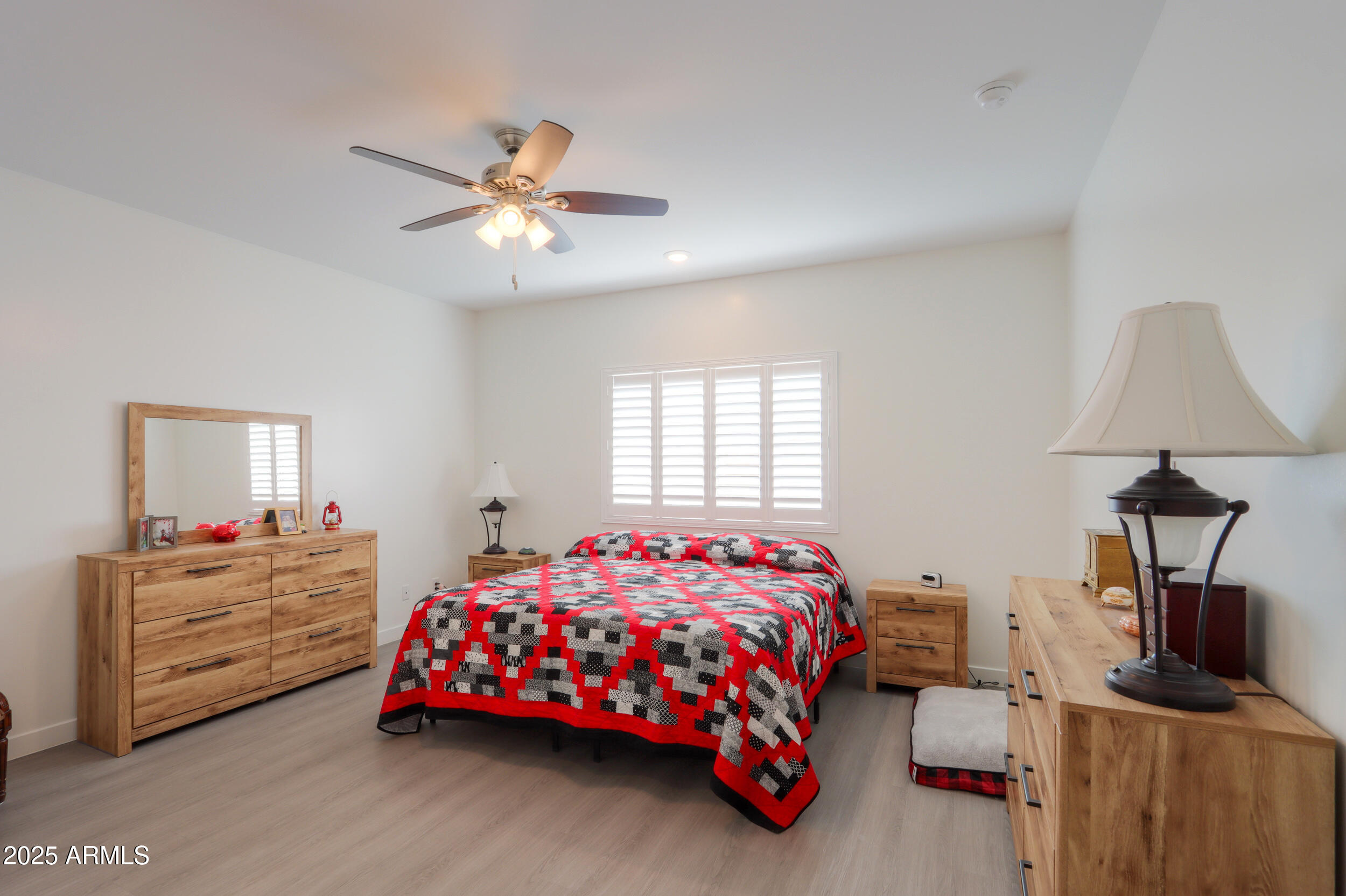 947 East Wiley Way Casa Grande, AZ 85122 - Photo 27 of 36 a bedroom with a bed and a chandelier