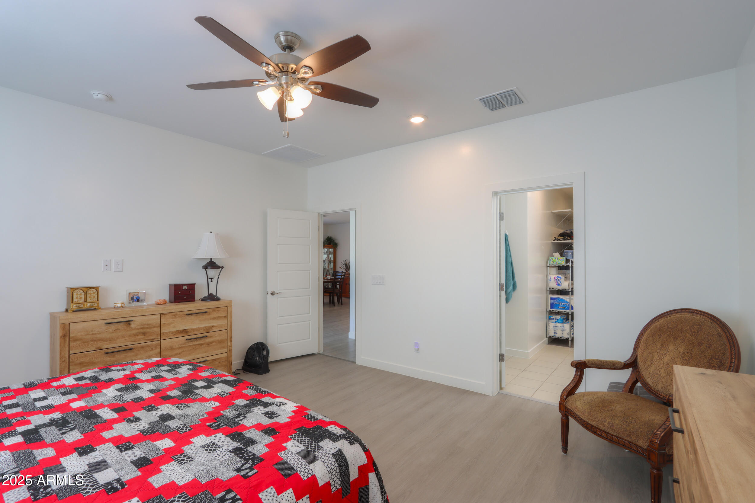947 East Wiley Way Casa Grande, AZ 85122 - Photo 28 of 36 a bedroom with a bed and a chandelier