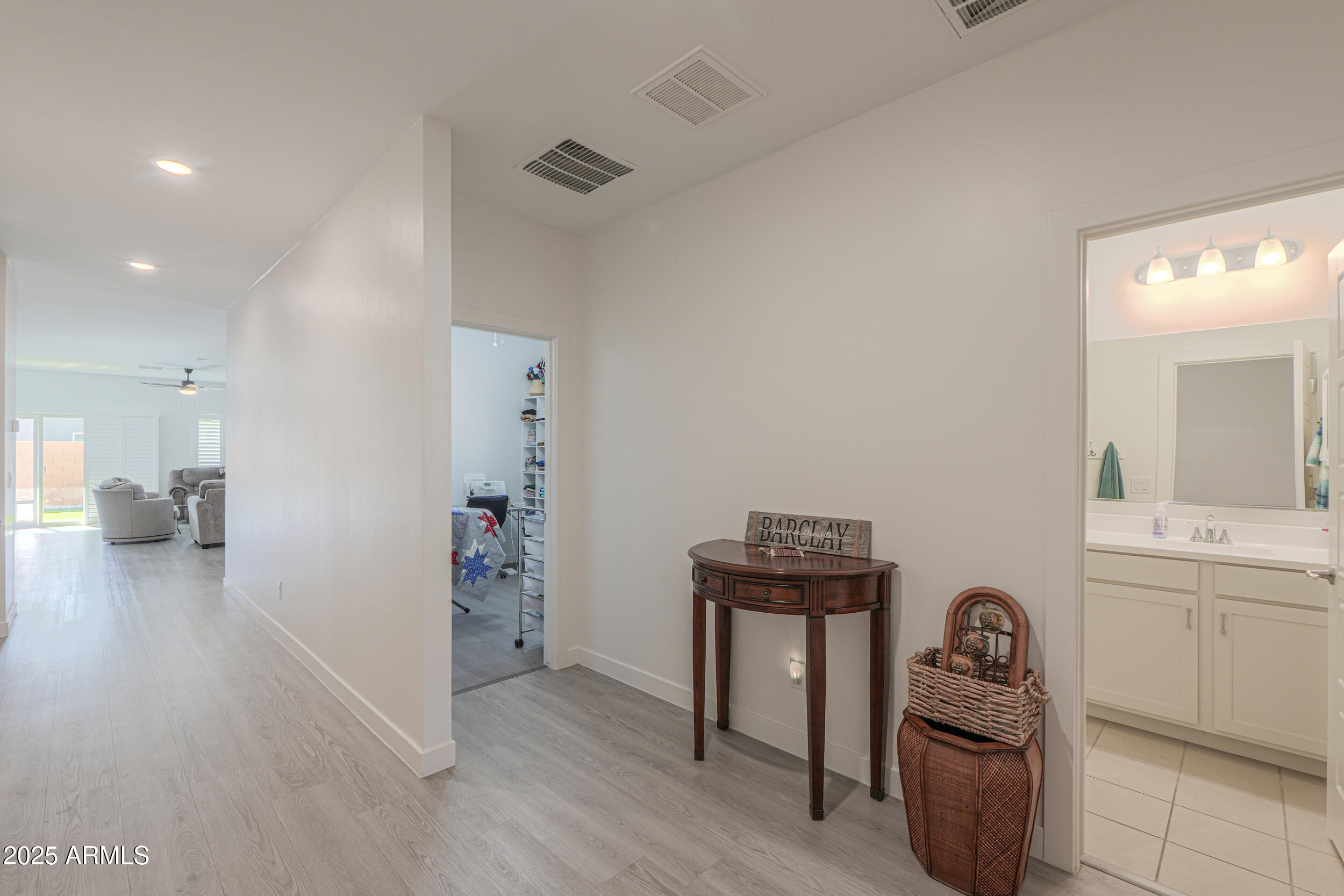 947 East Wiley Way Casa Grande, AZ 85122 - Photo 5 of 36 a hallway with a computer on a desk and chair