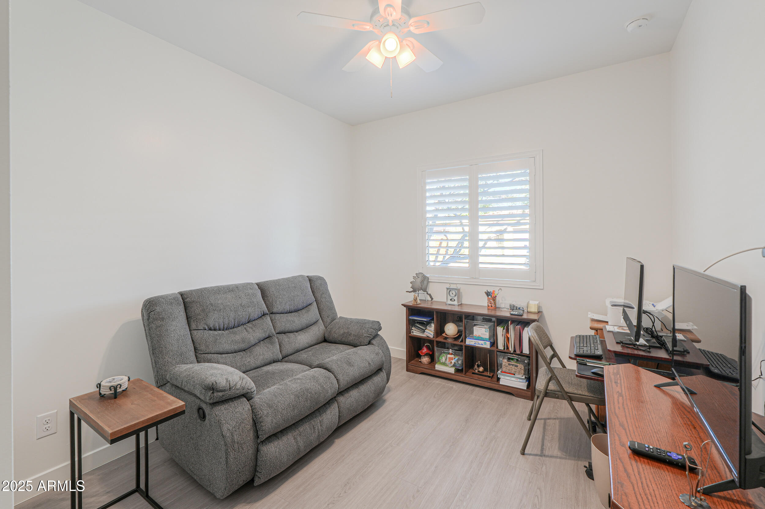 947 East Wiley Way Casa Grande, AZ 85122 - Photo 7 of 36 a living room with furniture a flat screen tv and a window