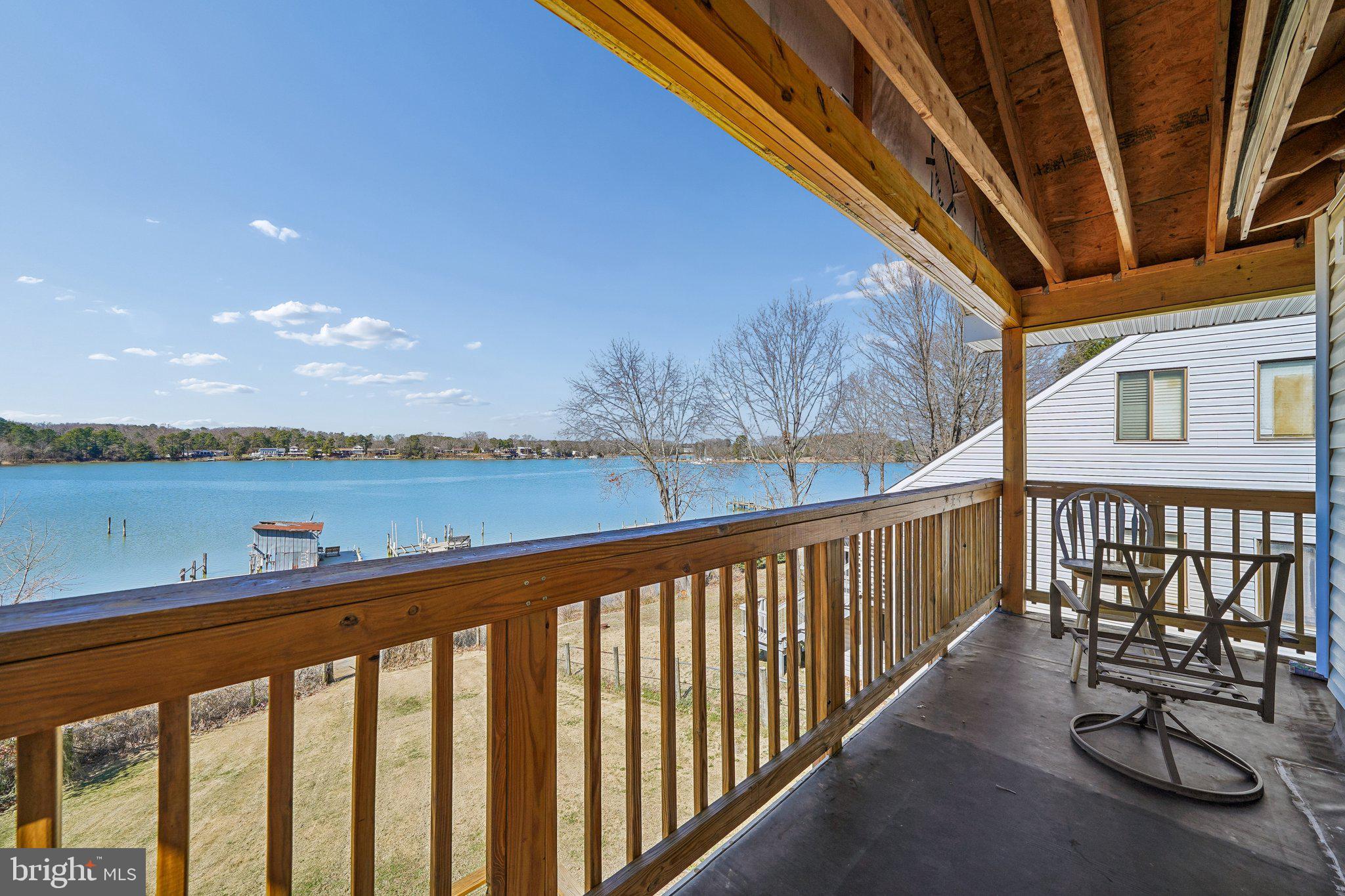 47 Bay View Drive Colonial Beach, VA 22443 - Photo 7 of 17 a balcony with outdoor seating and ocean view