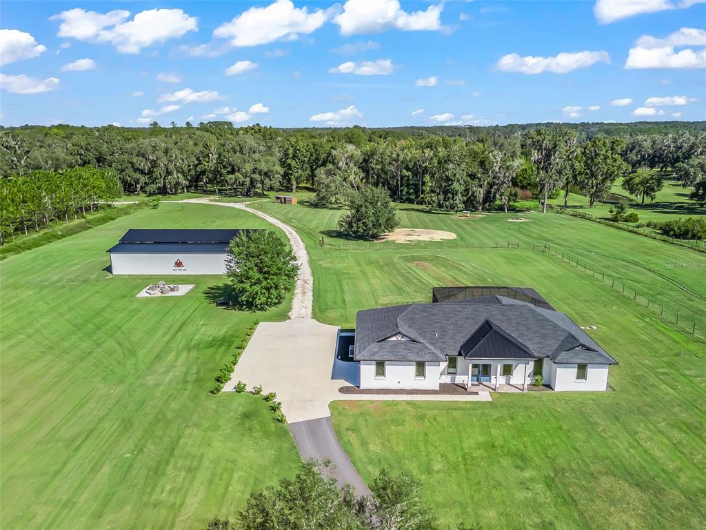 a view of a table and chairs in backyard of the house