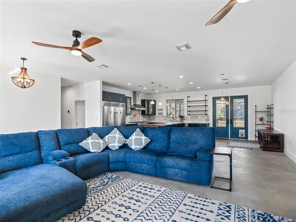 a kitchen with stainless steel appliances kitchen island granite countertop a table and chairs