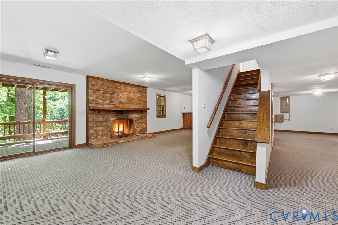 3201 East Brigstock Road Midlothian, VA 23113 - Photo 32 of 72 a view of an empty room with fireplace stairs and windows