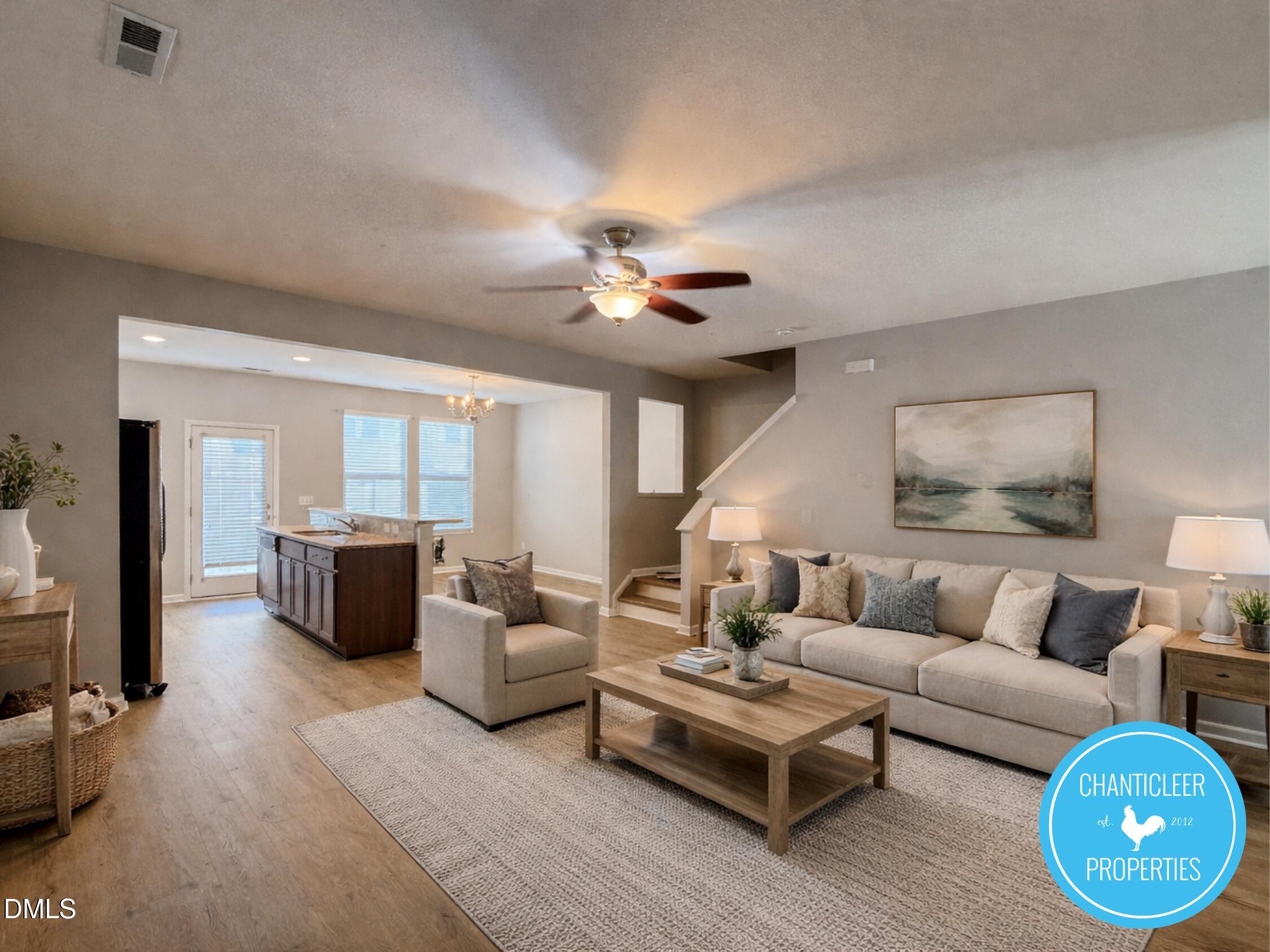 a living room with furniture ceiling fan and a rug