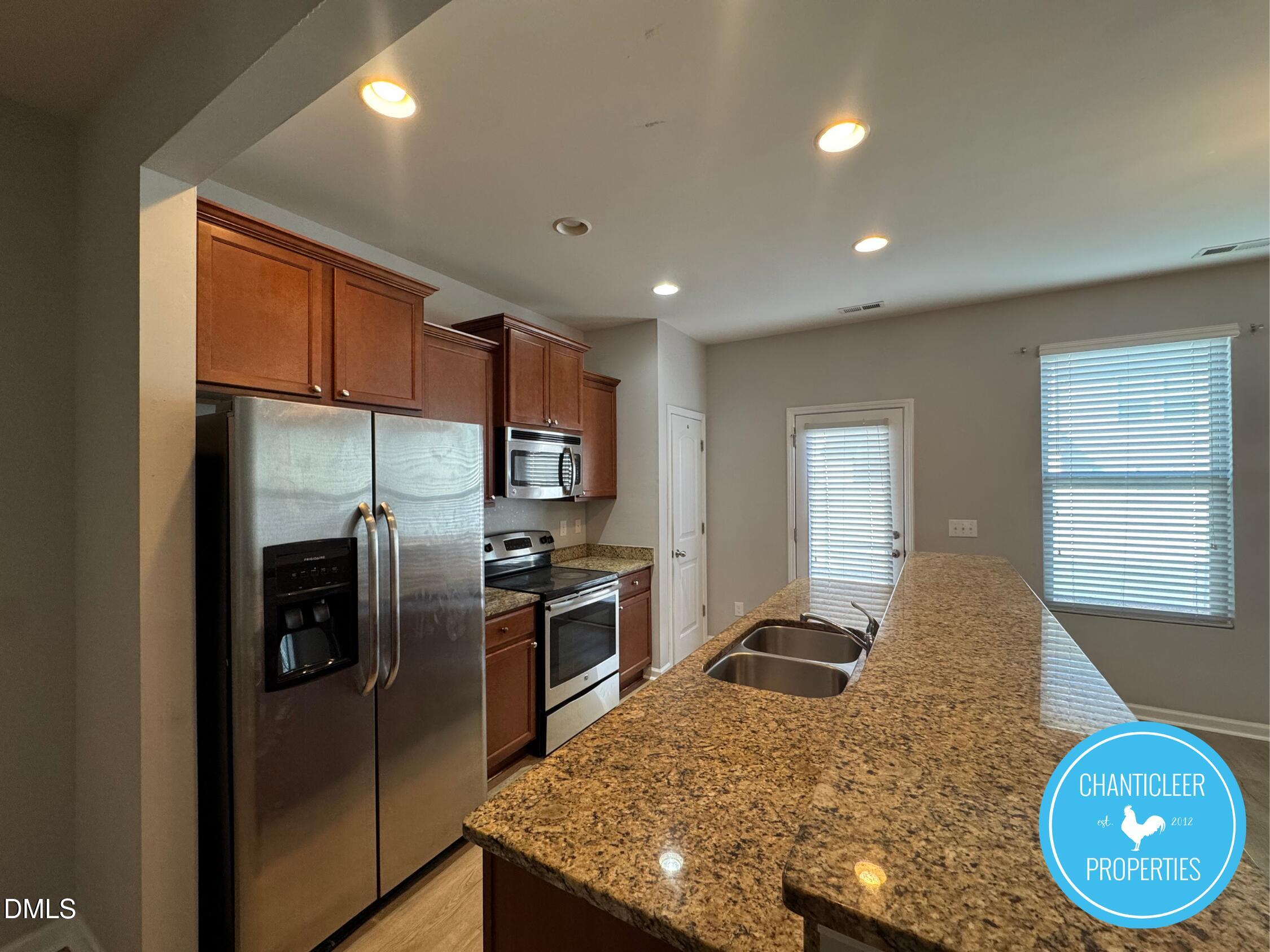 307 Leighann Ridge Lane Rolesville, NC 27571 - Photo 4 of 25 a kitchen with stainless steel appliances granite countertop a sink refrigerator and microwave