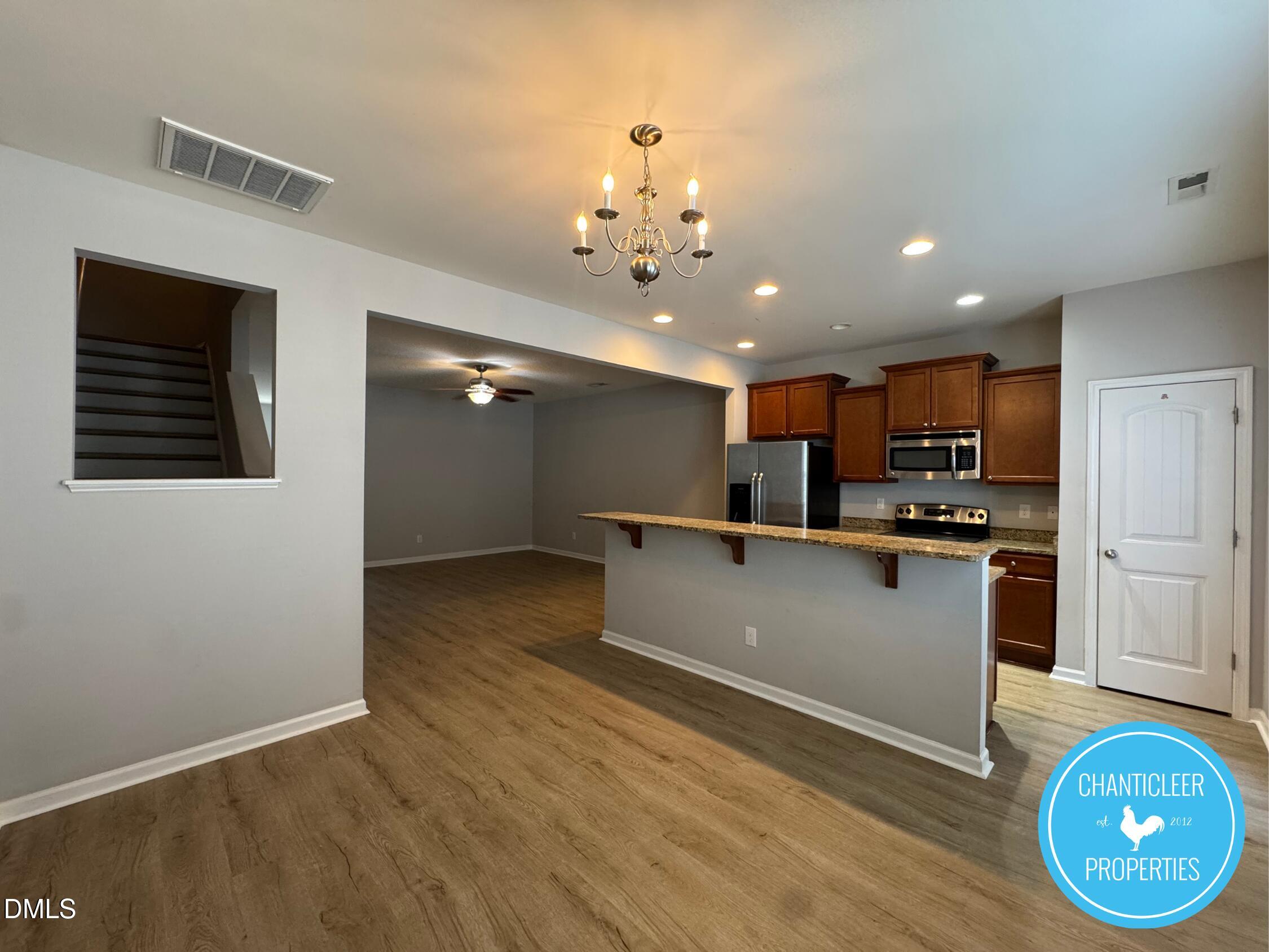 307 Leighann Ridge Lane Rolesville, NC 27571 - Photo 6 of 25 a large kitchen with kitchen island a sink stainless steel appliances and a chandelier