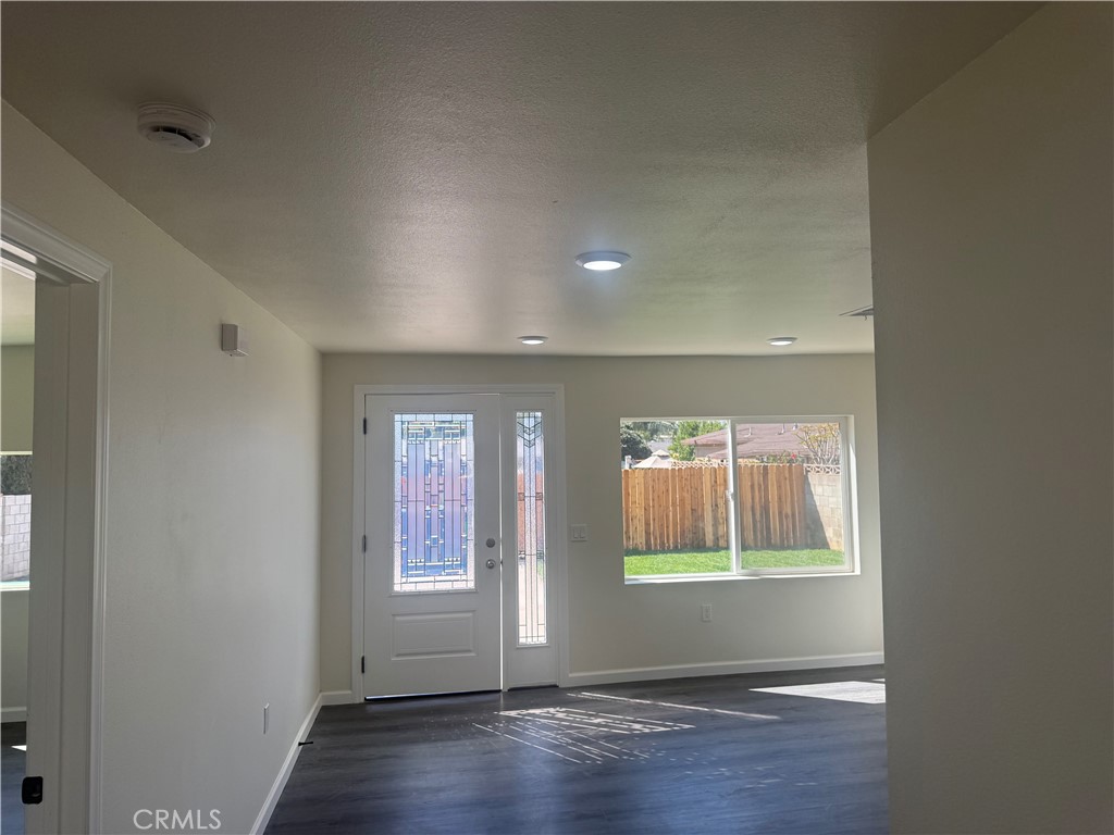 10337 Mull Avenue Riverside, CA 92505 - Photo 25 of 28 an empty room with wooden floor and windows