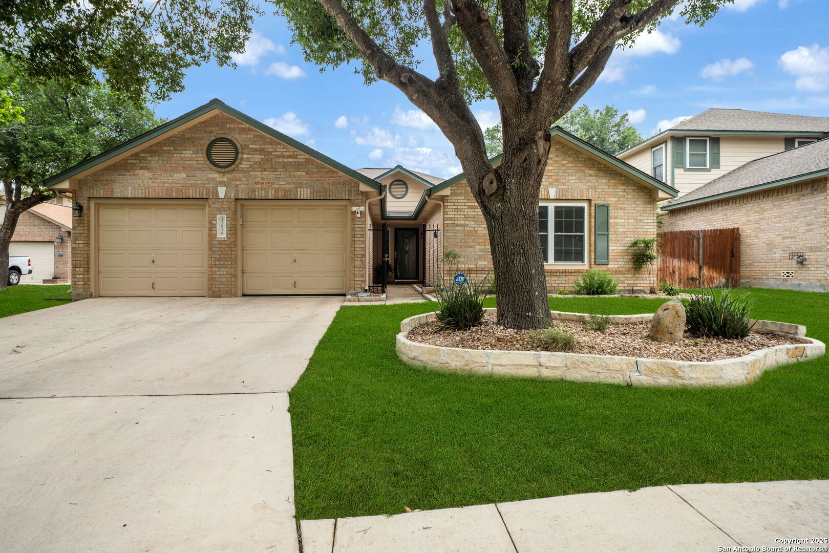 a front view of a house with a yard and potted plants