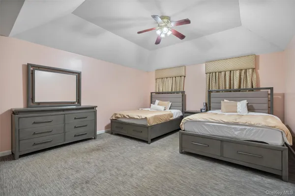 a spacious bedroom with a bed and a dresser