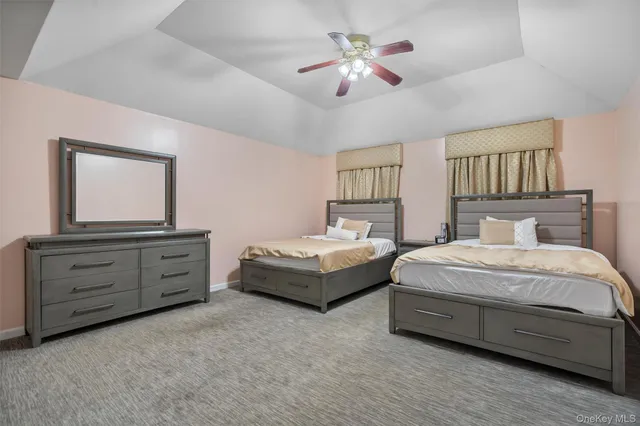 a spacious bedroom with a bed and a dresser