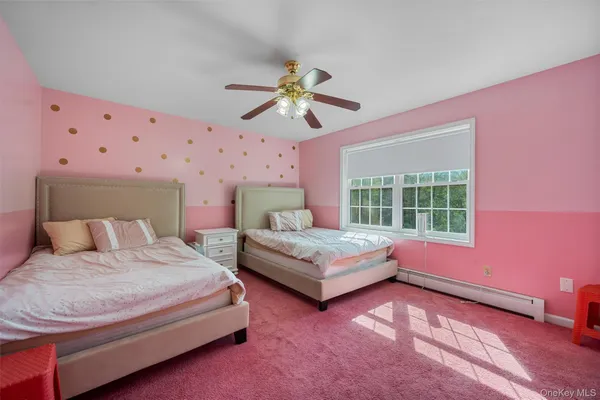 a bedroom with a bed chandelier and a window