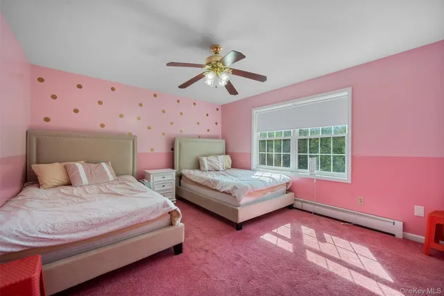 a bedroom with a bed chandelier and a window