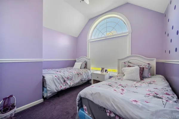 a bedroom with two beds and a window