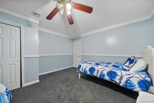 a bedroom with bed and a chandelier
