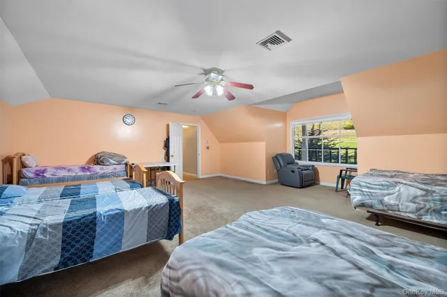 a spacious bedroom with a bed and a chandelier