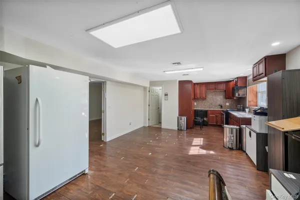 a view of a kitchen with furniture and wooden floor