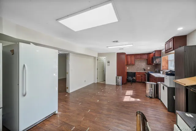 a view of a kitchen with furniture and wooden floor