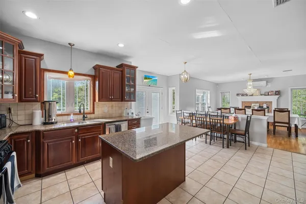 a large kitchen with lots of counter space and furniture