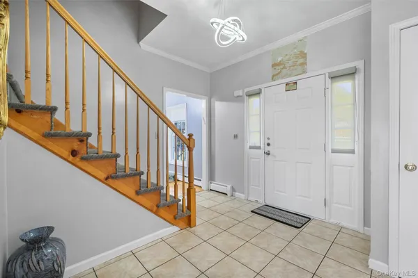 a view of an entryway with wooden floor and stairs