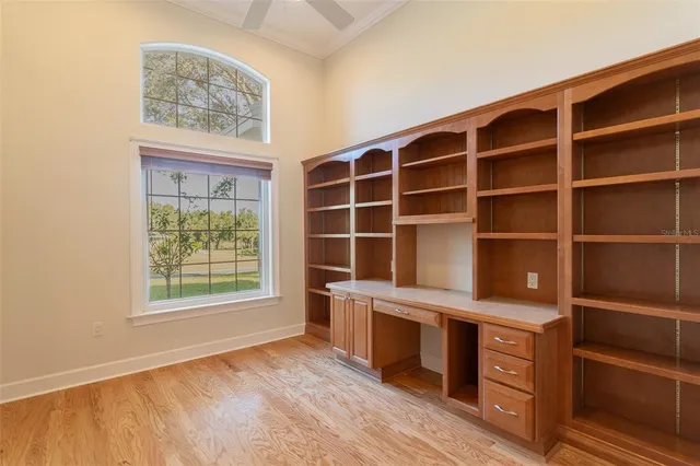 a view of a hardwood floor and windows in a room