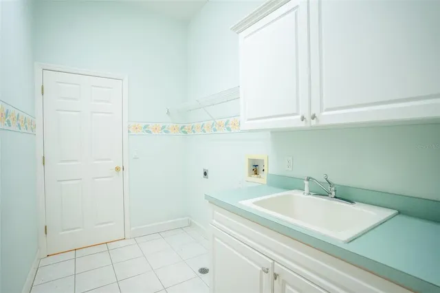 a view of a kitchen with white cabinets