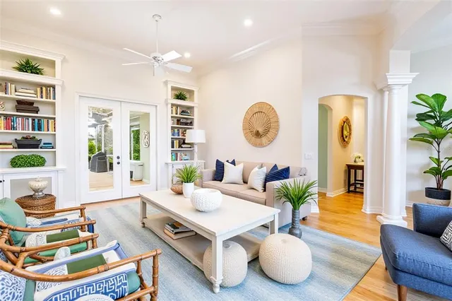 a living room with furniture and a wooden floor