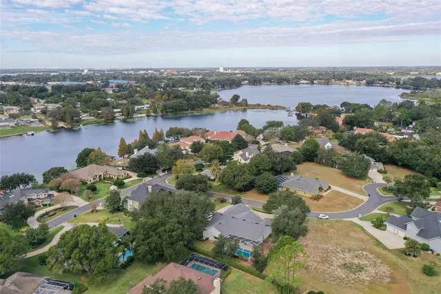 an aerial view of a city with lots of residential buildings lake and ocean view