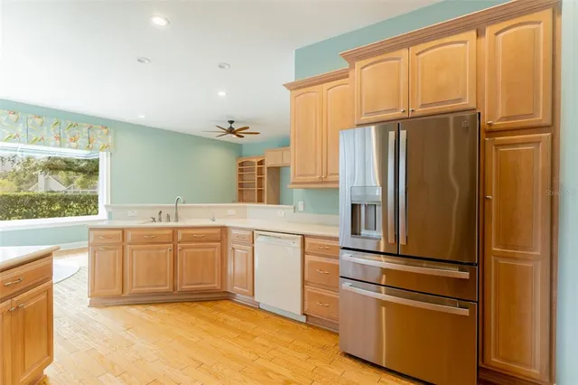 a kitchen with stainless steel appliances granite countertop a refrigerator and a sink