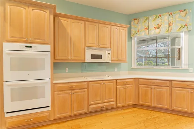 a kitchen with granite countertop white cabinets and sink