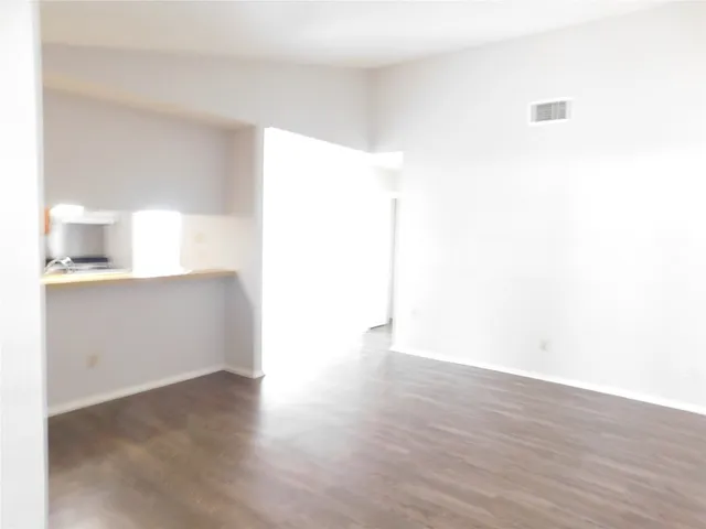 a view of a kitchen with wooden floor