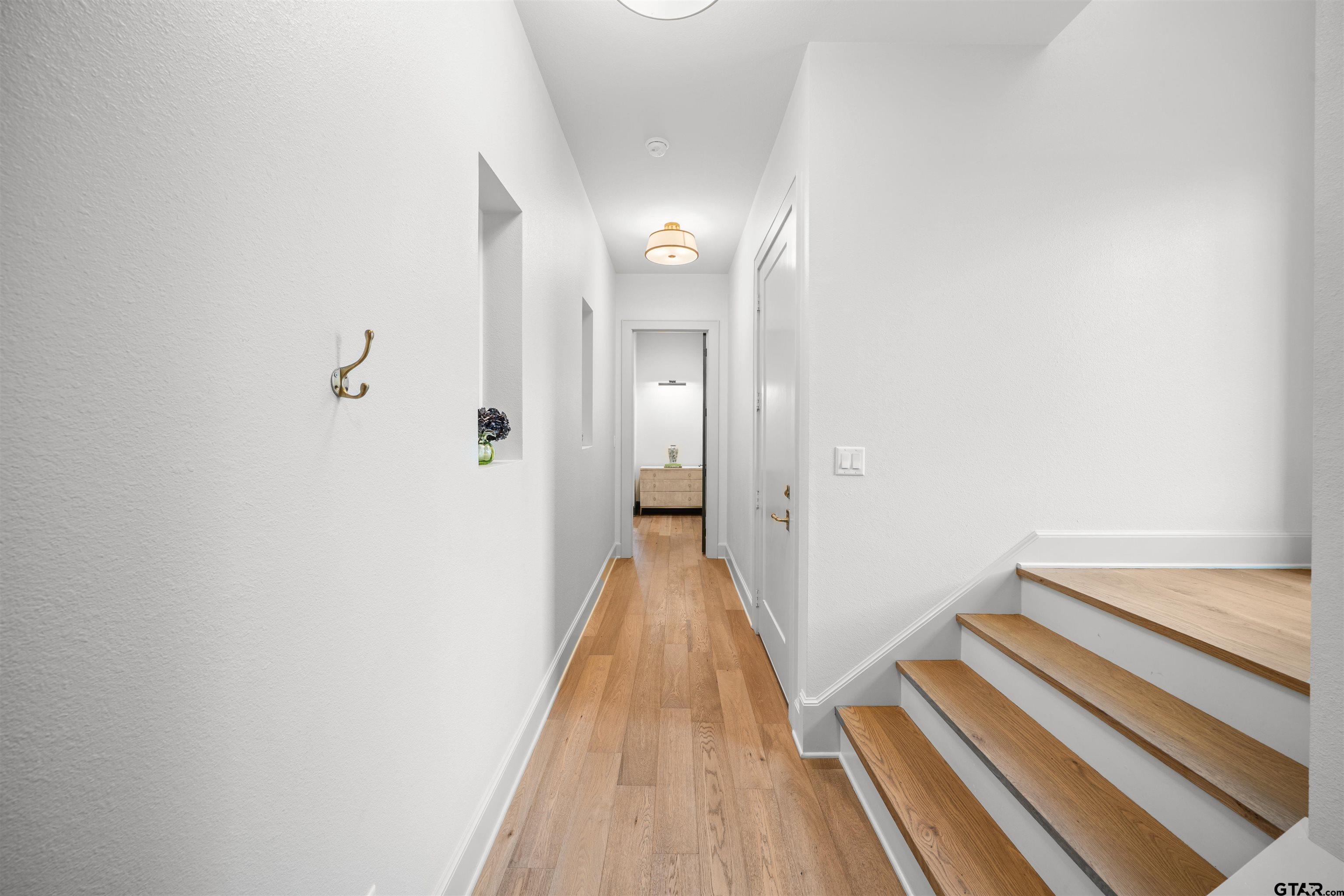 1555 Chaparrel Run Tyler, TX 75703 - Photo 28 of 48 a view of a hallway with wooden floor and staircase