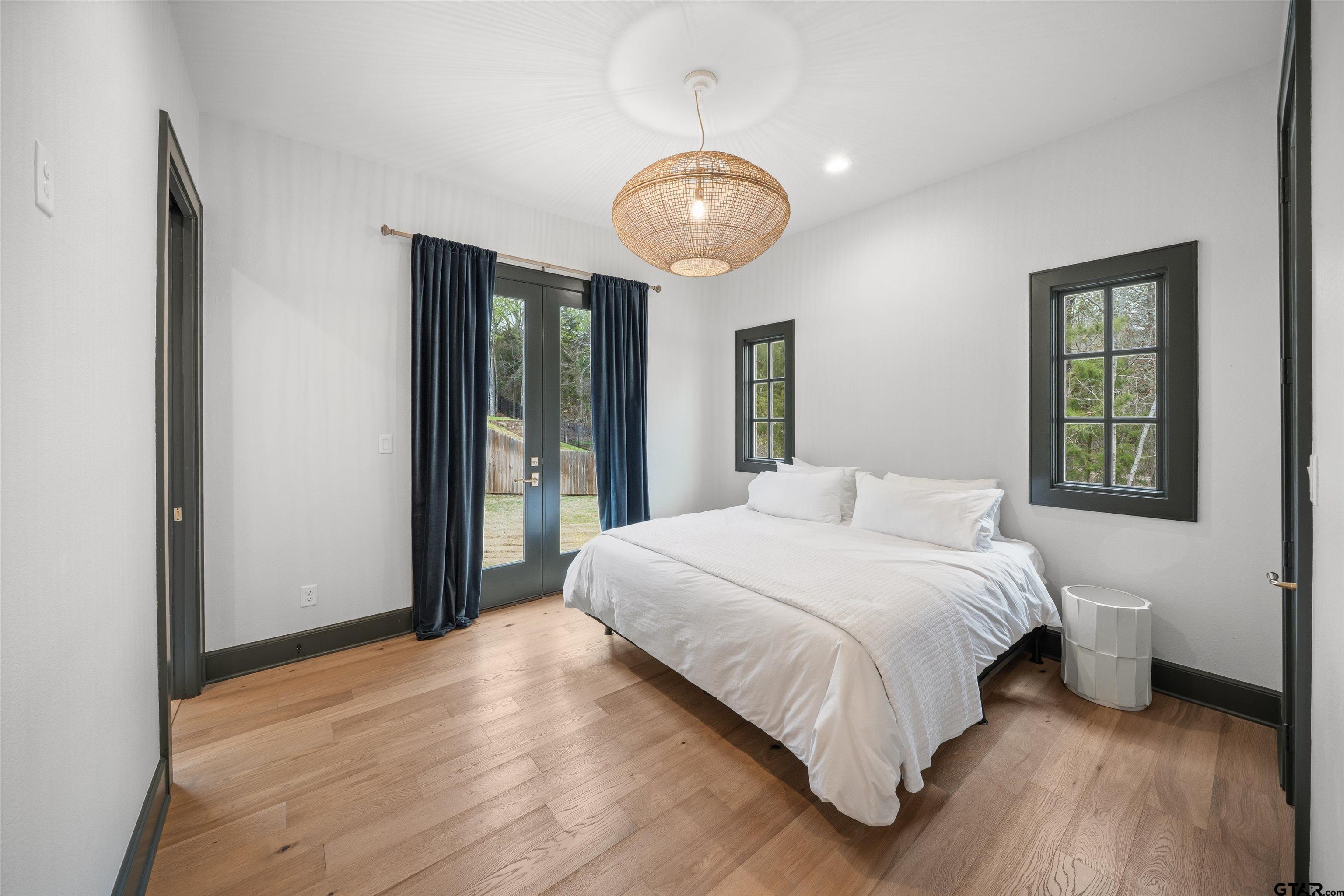 1555 Chaparrel Run Tyler, TX 75703 - Photo 29 of 48 a bedroom with a large bed and a large window