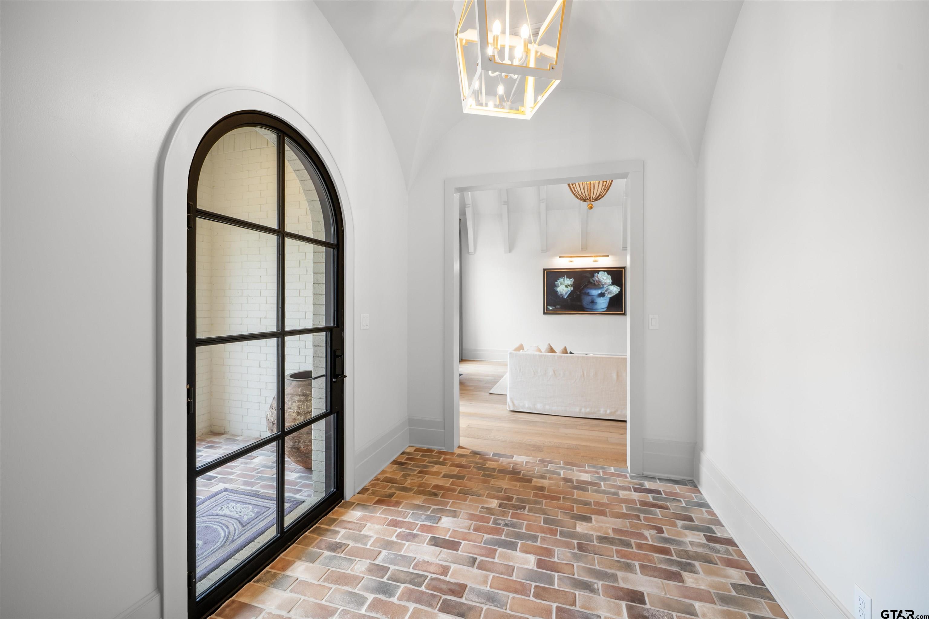 1555 Chaparrel Run Tyler, TX 75703 - Photo 3 of 48 a view of a hallway view with wooden floor and a dining room