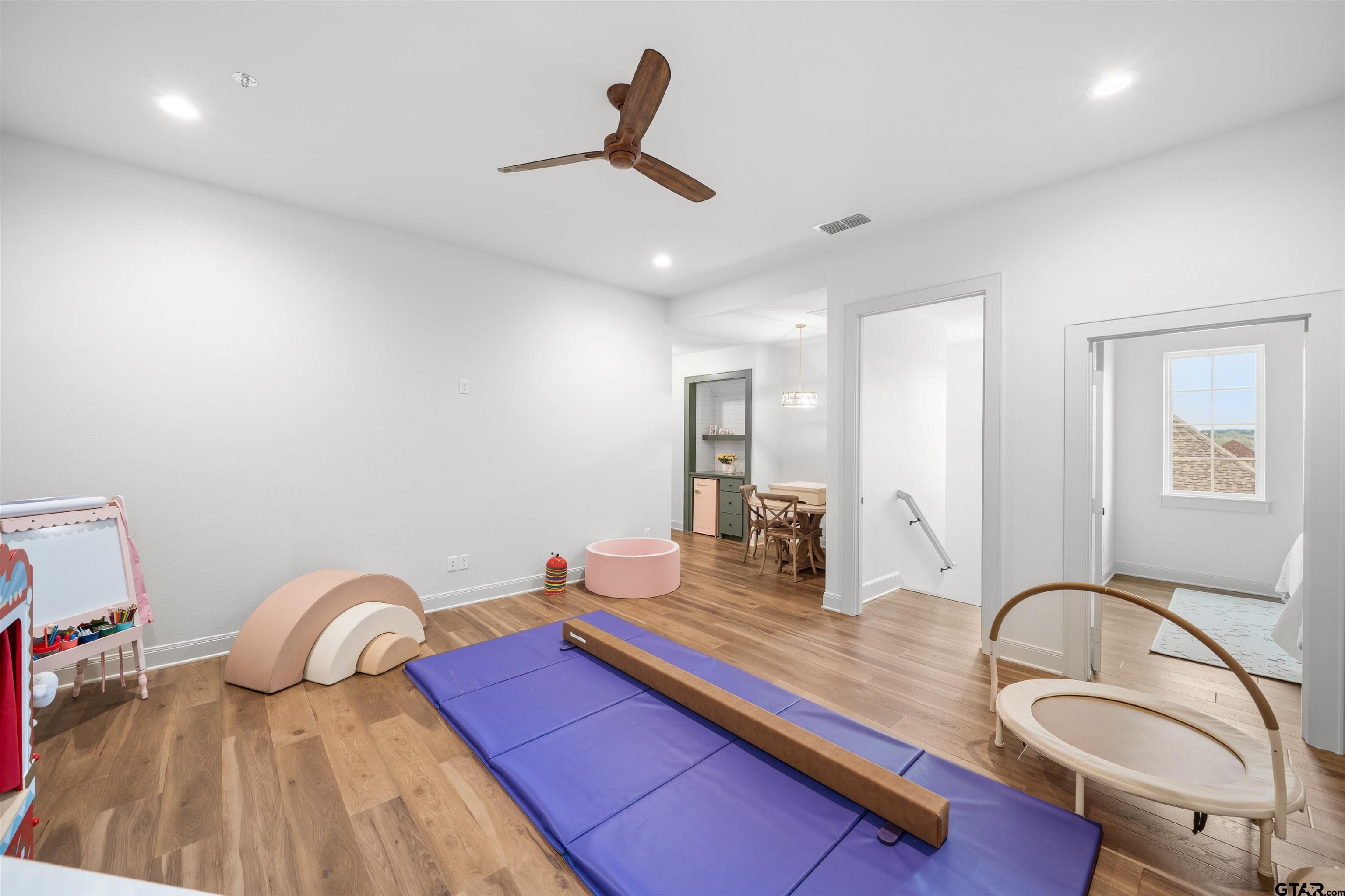 1555 Chaparrel Run Tyler, TX 75703 - Photo 33 of 48 a room with a bed furniture and wooden floor