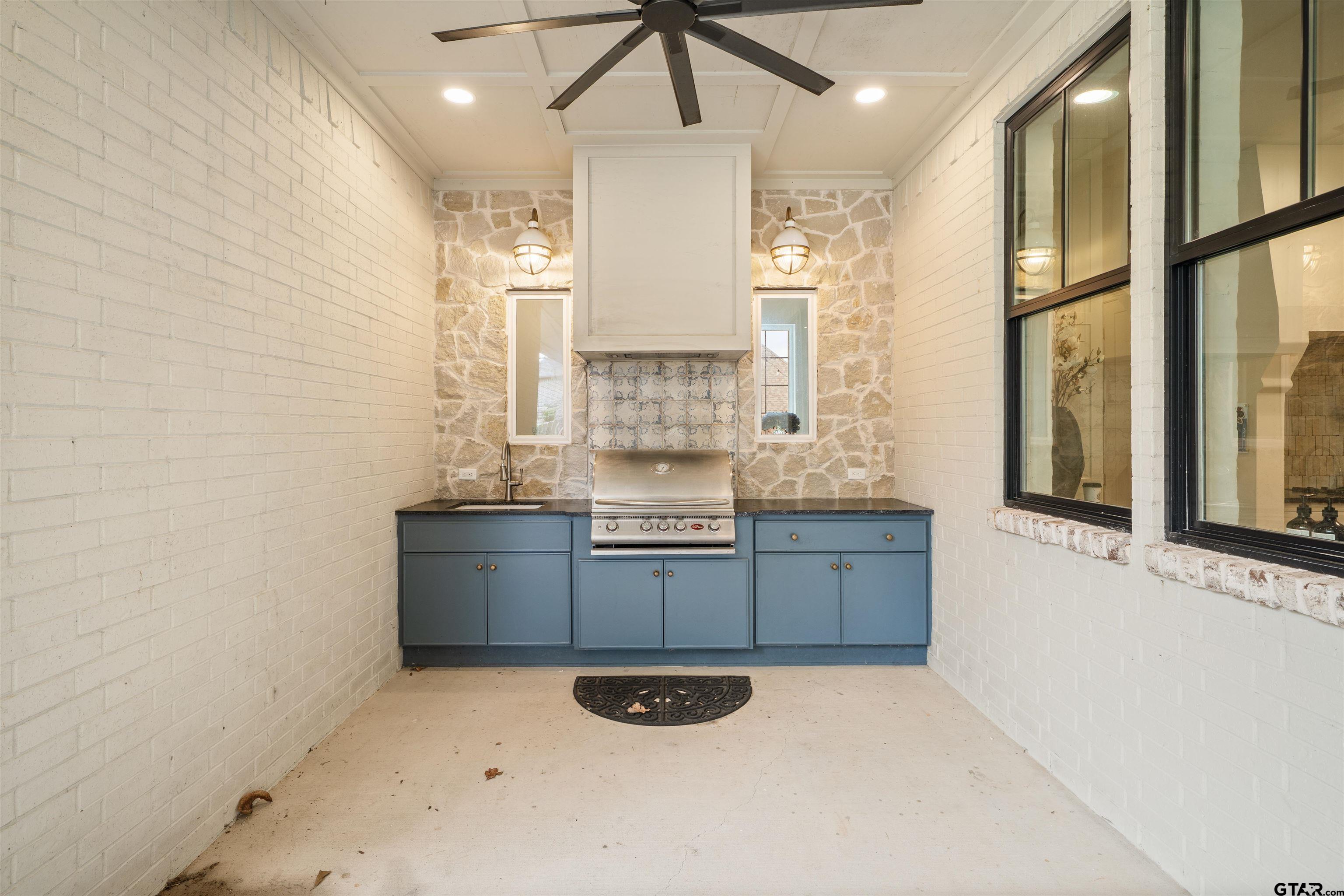 1555 Chaparrel Run Tyler, TX 75703 - Photo 43 of 48 a kitchen with granite countertop a stove a sink and a refrigerator
